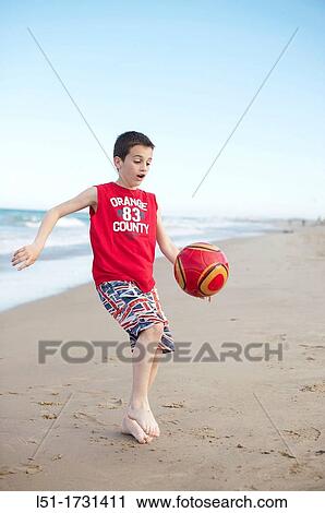 Boy playing football at the beach, El Saler beach, Albufera de Valencia Nature Reserve, Spain, Valencia View Large Photo Image Stock Image - Boy playing football at the beach, El Saler beach, Albufera de Valencia Nature Reserve, Spain, Valencia. Fotosearch