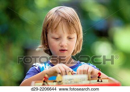 Boy Playing Football Board Game Outdoors. View Large Photo Image Picture - Boy Playing Football Board Game Outdoors.. Fotosearch
