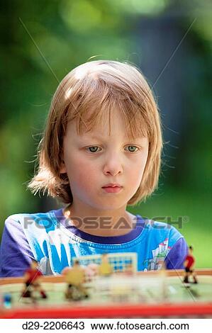 Boy Playing Football Board Game Outdoors. View Large Photo Image Stock Image - Boy Playing Football Board Game Outdoors.. Fotosearch