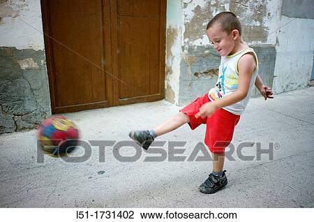 boy playing football on a village, Ludiente, Castell? Un, Spain View Large Photo Image Stock Image - boy playing football on a village, Ludiente, Castell? Un, Spain. Fotosearch