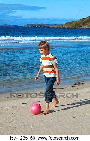 boy playing football on beach, Sutherland, Scotland View Large Photo Image Stock Image - boy playing football on beach, Sutherland, Scotland. Fotosearch