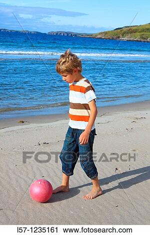 boy playing football on beach, Sutherland, Scotland View Large Photo Image Stock Image - boy playing football on beach, Sutherland, Scotland. Fotosearch