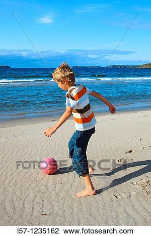 boy playing football on beach, Sutherland, Scotland View Large Photo Image Stock Image - boy playing football on beach, Sutherland, Scotland. Fotosearch