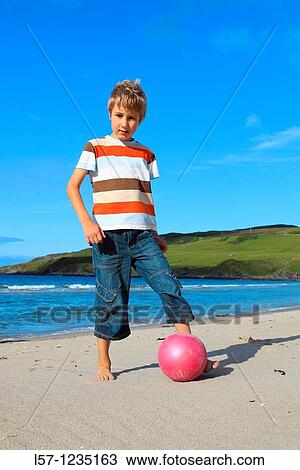 boy playing football on beach, Sutherland, Scotland View Large Photo Image Stock Image - boy playing football on beach, Sutherland, Scotland. Fotosearch