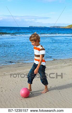 boy playing football on beach, Sutherland, Scotland View Large Photo Image Stock Photo - boy playing football on beach, Sutherland, Scotland. Fotosearch