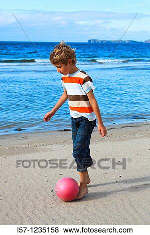 boy playing football on beach, Sutherland, Scotland View Large Photo Image Stock Photo - boy playing football on beach, Sutherland, Scotland. Fotosearch