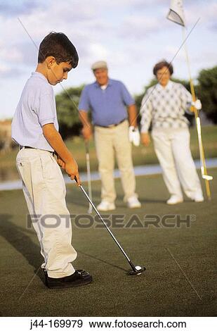 Boy playing golf with his grandparents View Large Photo Image Stock Photo - Boy playing golf with his grandparents. Fotosearch
