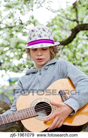 Stock Photo - Boy playing guitar.. Fotosearch