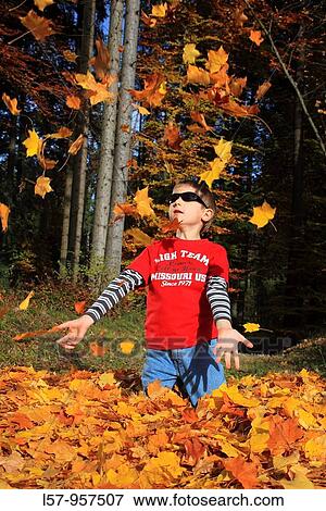 boy playing in pile of leaves, fall Zuerich, Switzerland View Large Photo Image Stock Photo - boy playing in pile of leaves, fall Zuerich, Switzerland. Fotosearch