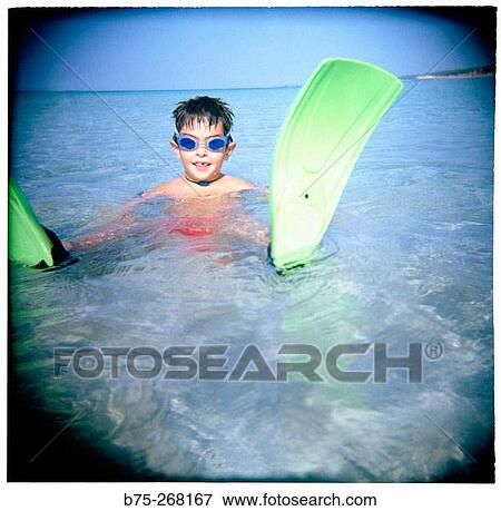 Boy playing in the water View Large Photo Image Stock Photo - Boy playing in the water. Fotosearch