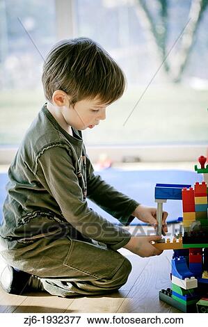 Boy playing indoor with bricks. View Large Photo Image Stock Photo - Boy playing indoor with bricks.. Fotosearch