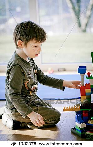 Boy playing indoor with bricks. View Large Photo Image Stock Photo - Boy playing indoor with bricks.. Fotosearch