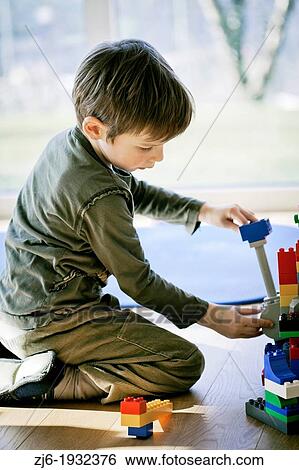 Boy playing indoor with bricks. View Large Photo Image Stock Photograph - Boy playing indoor with bricks.. Fotosearch