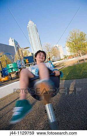 Stock Photo - Boy playing on a children's playground at Curtis Hixon Waterfront Park. Fotosearch