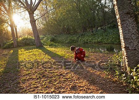 Boy playing on a park in the afternoon View Large Photo Image Stock Image - Boy playing on a park in the afternoon. Fotosearch