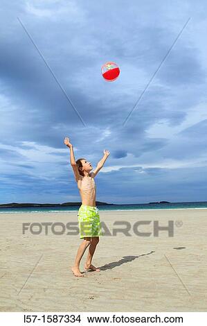 boy playing on sandy beach, Sutherland, Scotland View Large Photo Image Picture - boy playing on sandy beach, Sutherland, Scotland. Fotosearch