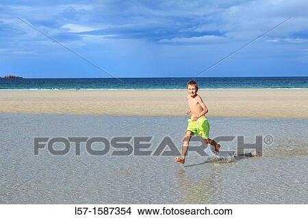 boy playing on sandy beach, Sutherland, Scotland View Large Photo Image Picture - boy playing on sandy beach, Sutherland, Scotland. Fotosearch