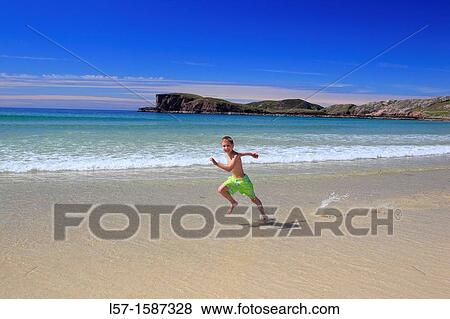 boy playing on sandy beach, Sutherland, Scotland View Large Photo Image Stock Photo - boy playing on sandy beach, Sutherland, Scotland. Fotosearch