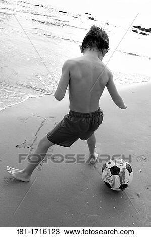 Boy playing soccer on the beach View Large Photo Image Stock Image - Boy playing soccer on the beach. Fotosearch