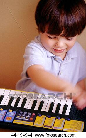 Boy playing the keyboard View Large Photo Image Picture - Boy playing the keyboard. Fotosearch
