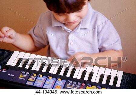 Boy playing the keyboard View Large Photo Image Stock Photography - Boy playing the keyboard. Fotosearch