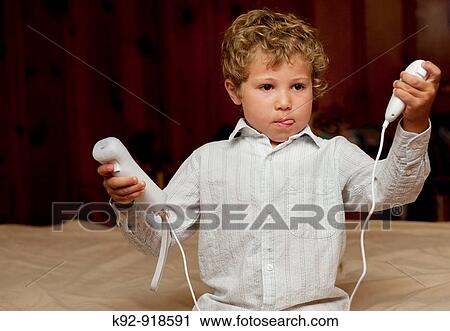 Stock Image - Boy playing the Wii. Fotosearch