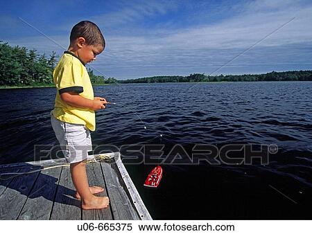 Stock Photography - Boy playing with a radio-control boat. Fotosearch