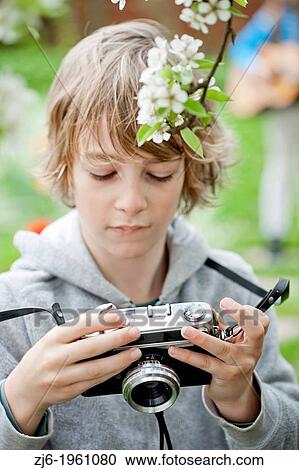 Boy playing with an old camera. View Large Photo Image Stock Image - Boy playing with an old camera.. Fotosearch