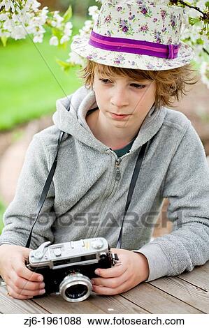 Boy playing with an old camera. View Large Photo Image Stock Photo - Boy playing with an old camera.. Fotosearch
