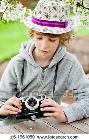 Boy playing with an old camera. View Large Photo Image Stock Photo - Boy playing with an old camera.. Fotosearch