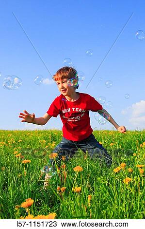 boy playing with bubbles in field of Dandelions, Zuercher Oberland, Zuerich, Switzerland View Large Photo Image Stock Image - boy playing with bubbles in field of Dandelions, Zuercher Oberland, Zuerich, Switzerland. Fotosearch