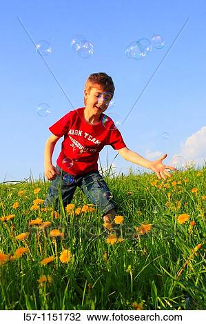 boy playing with bubbles in field of Dandelions, Zuercher Oberland, Zuerich, Switzerland View Large Photo Image Stock Image - boy playing with bubbles in field of Dandelions, Zuercher Oberland, Zuerich, Switzerland. Fotosearch