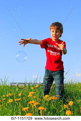 boy playing with bubbles in field of Dandelions, Zuercher Oberland, Zuerich, Switzerland View Large Photo Image Stock Photo - boy playing with bubbles in field of Dandelions, Zuercher Oberland, Zuerich, Switzerland. Fotosearch