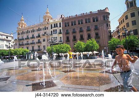 Boy playing with fountain water. C? rdoba. Spain View Large Photo Image Stock Image - Boy playing with fountain water. C? rdoba. Spain. Fotosearch