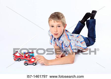 Stock Photo - Boy playing with Lego fire engines, Switzerland. Fotosearch