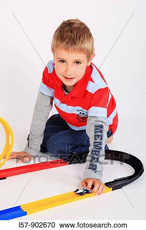 boy playing with racing car on floor, white background, Studio, Switzerland View Large Photo Image Stock Image - boy playing with racing car on floor, white background, Studio, Switzerland. Fotosearch