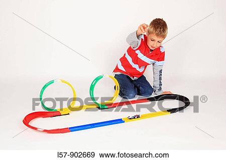 boy playing with racing car on floor, white background, Studio, Switzerland View Large Photo Image Stock Photo - boy playing with racing car on floor, white background, Studio, Switzerland. Fotosearch