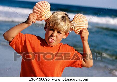 Boy playing with seeshells View Large Photo Image Stock Photography - Boy playing with seeshells. Fotosearch
