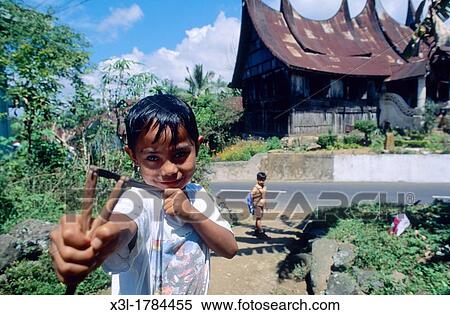 Boy playing with slingshot in Pagaruyung Minangkabau Sumatra Indonesia View Large Photo Image Stock Photography - Boy playing with slingshot in Pagaruyung Minangkabau Sumatra Indonesia. Fotosearch
