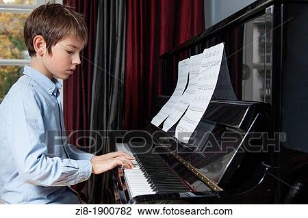 Boy plays the piano View Large Photo Image Stock Image - Boy plays the piano. Fotosearch