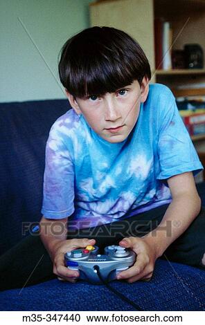 Boy plays videogame View Large Photo Image Stock Image - Boy plays videogame. Fotosearch
