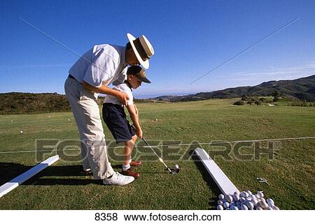 Boy practicing golf View Large Photo Image Stock Photo - Boy practicing golf. Fotosearch