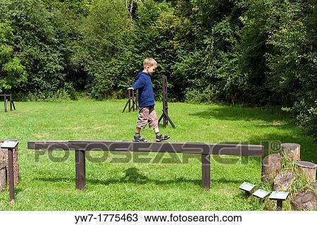 Boy practising on balance beam View Large Photo Image Stock Image - Boy practising on balance beam. Fotosearch