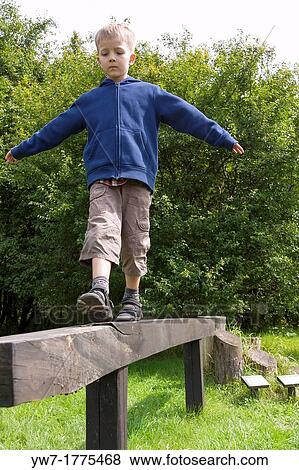 Boy practising on balance beam View Large Photo Image Stock Photo - Boy practising on balance beam. Fotosearch