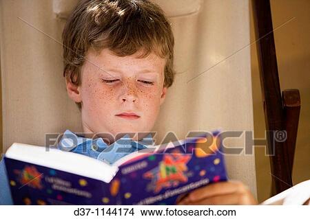Boy reading a book View Large Photo Image Picture - Boy reading a book. Fotosearch