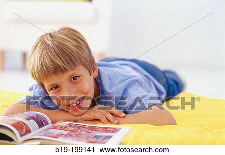 Boy reading a book View Large Photo Image Stock Image - Boy reading a book. Fotosearch