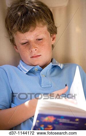 Boy reading a book View Large Photo Image Stock Image - Boy reading a book. Fotosearch