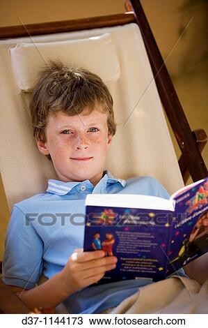 Boy reading a book View Large Photo Image Stock Image - Boy reading a book. Fotosearch