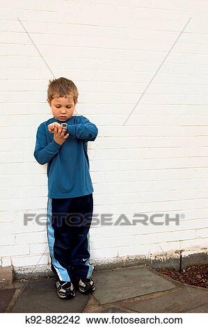 Boy reading his watch View Large Photo Image Stock Image - Boy reading his watch. Fotosearch