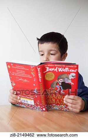 Boy reads a book. View Large Photo Image Stock Image - Boy reads a book.. Fotosearch